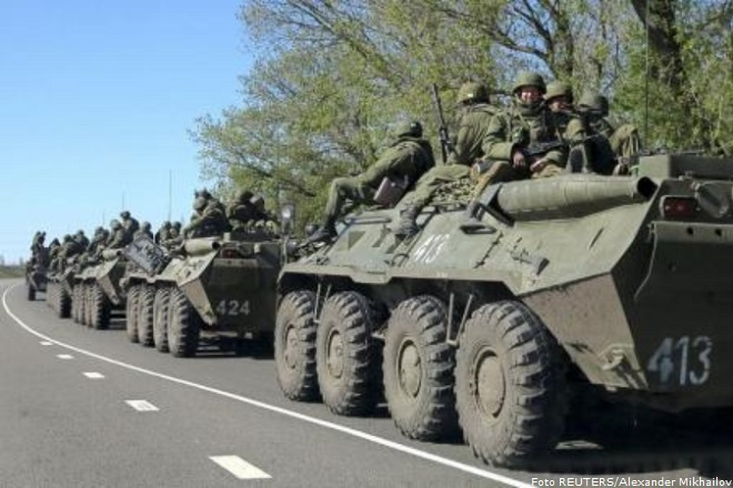 Russian servicemen drive armoured personnel carriers on the outskirts of the city of Belgorod